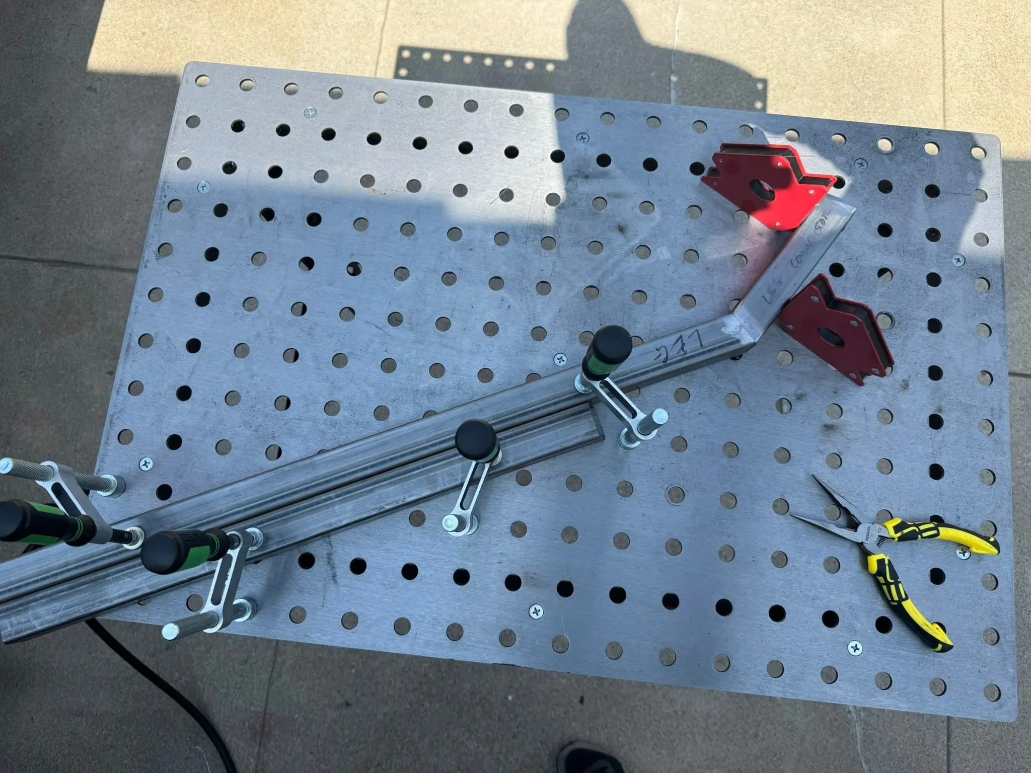 A steel fixturing table with a leg clamped in printed fixtures