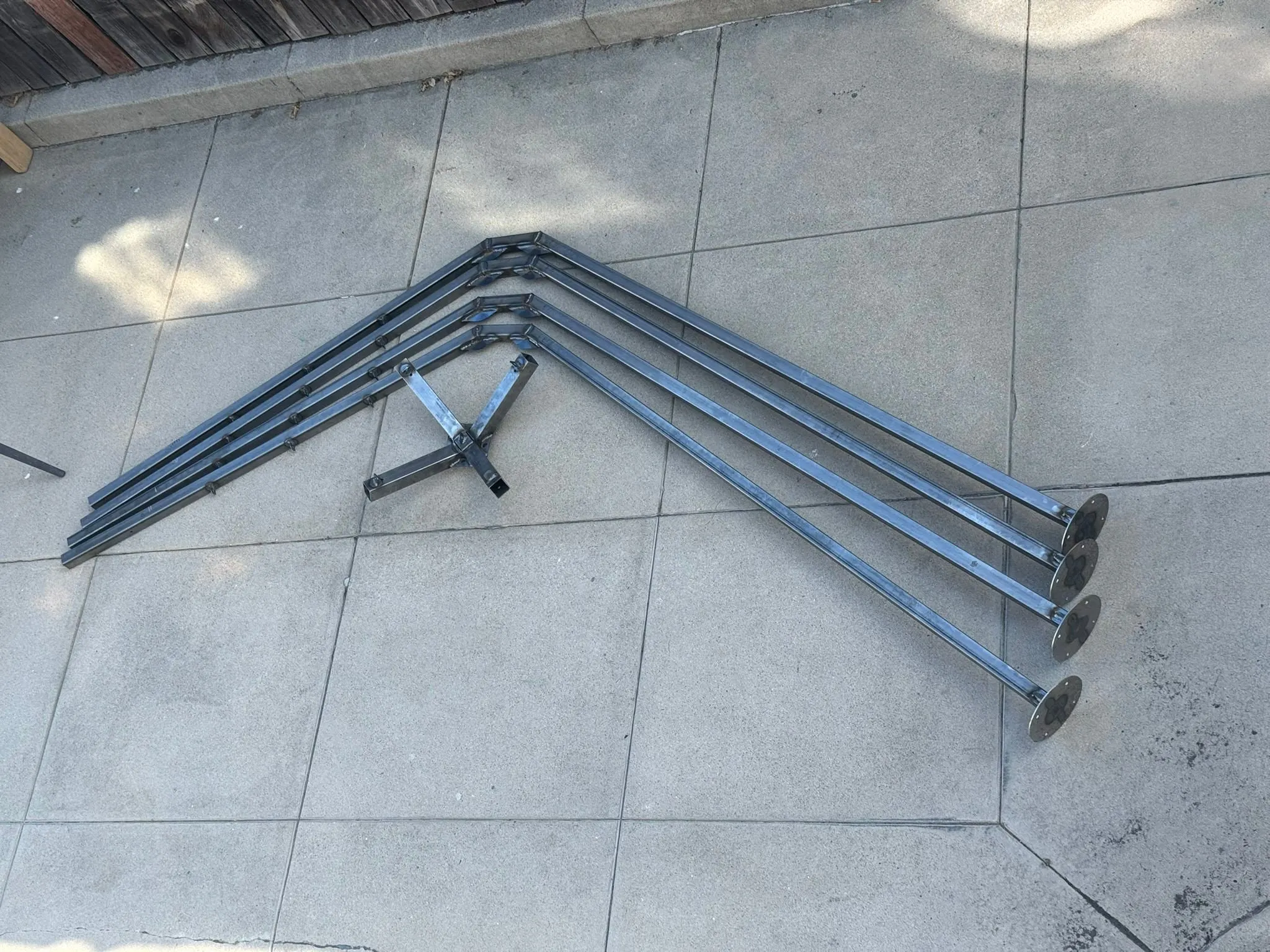 Finished bare-steel legs laid out on concrete