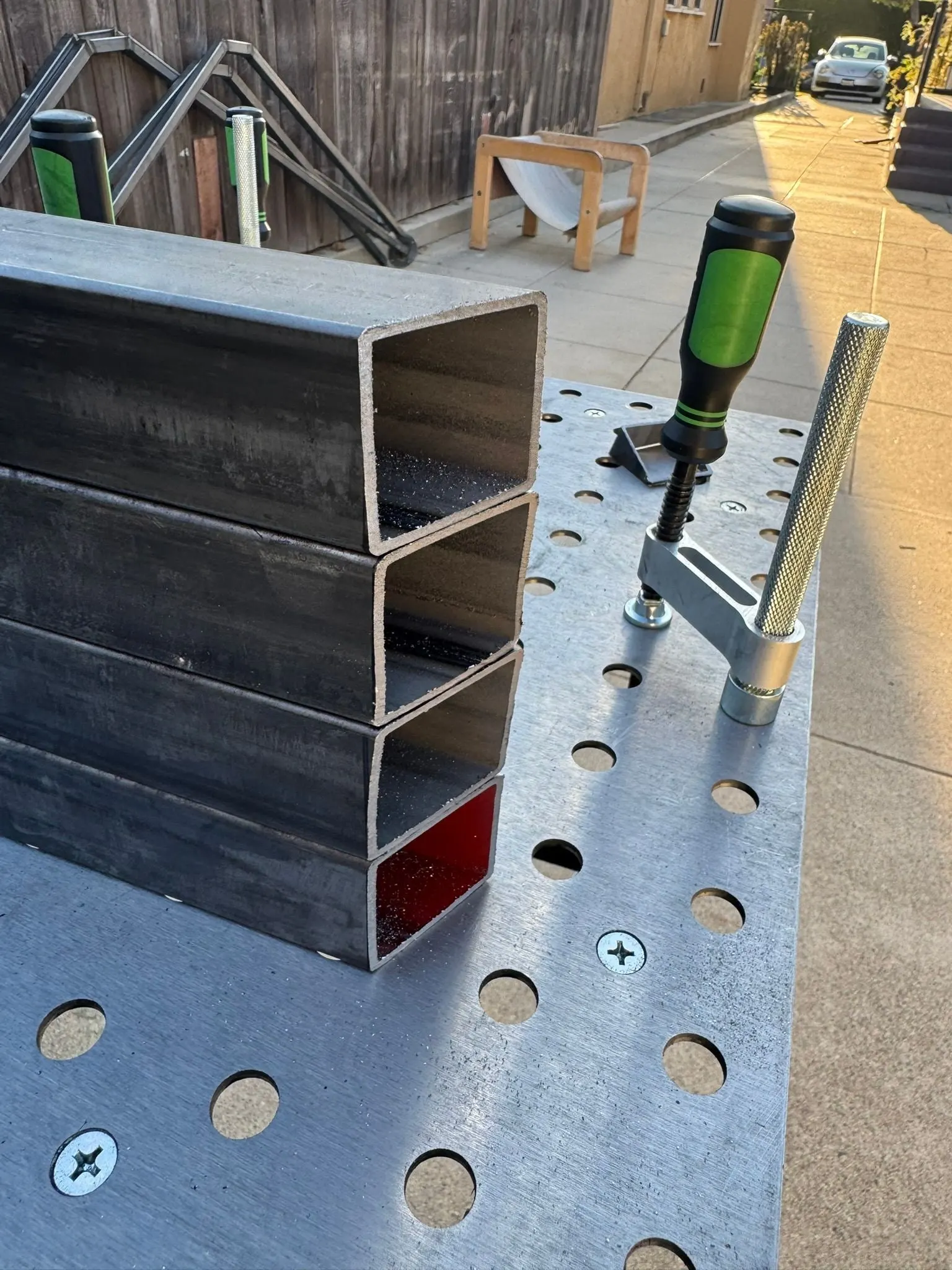 Square tubes on a fixture table, marked for cutting