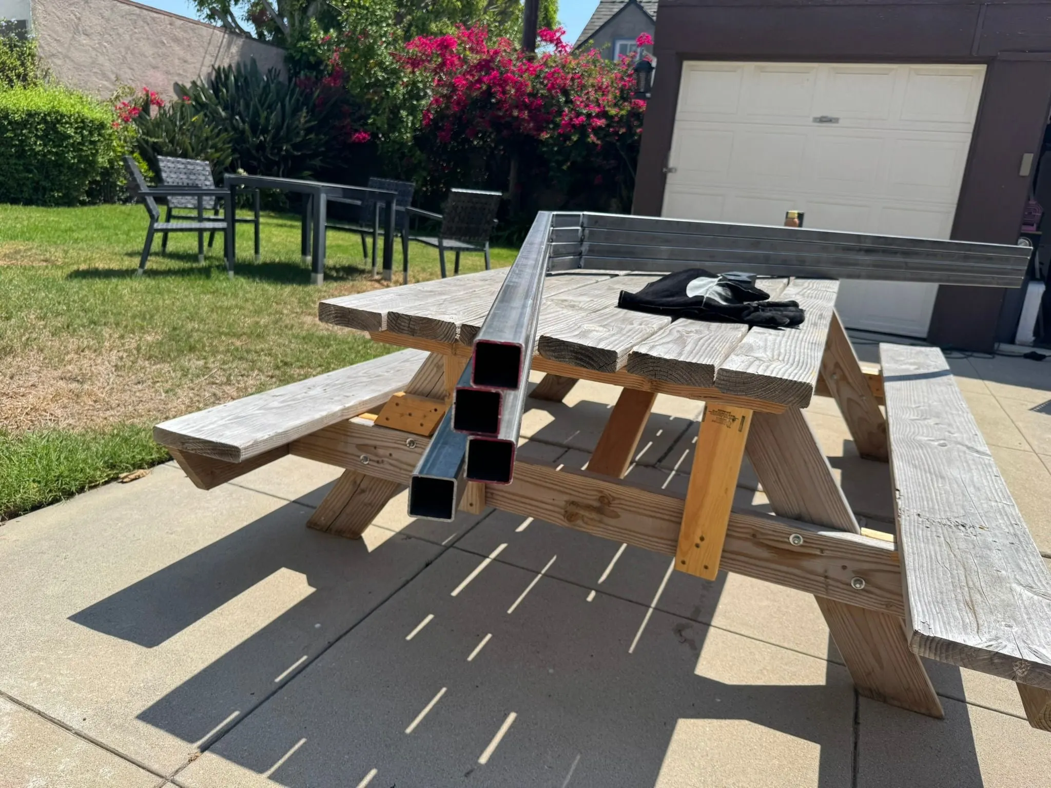 Steel tubes laid out on a picnic table in the backyard