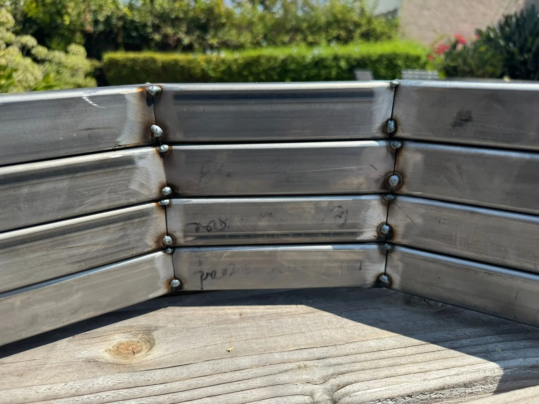Tack-welded leg segments leaning against a bench