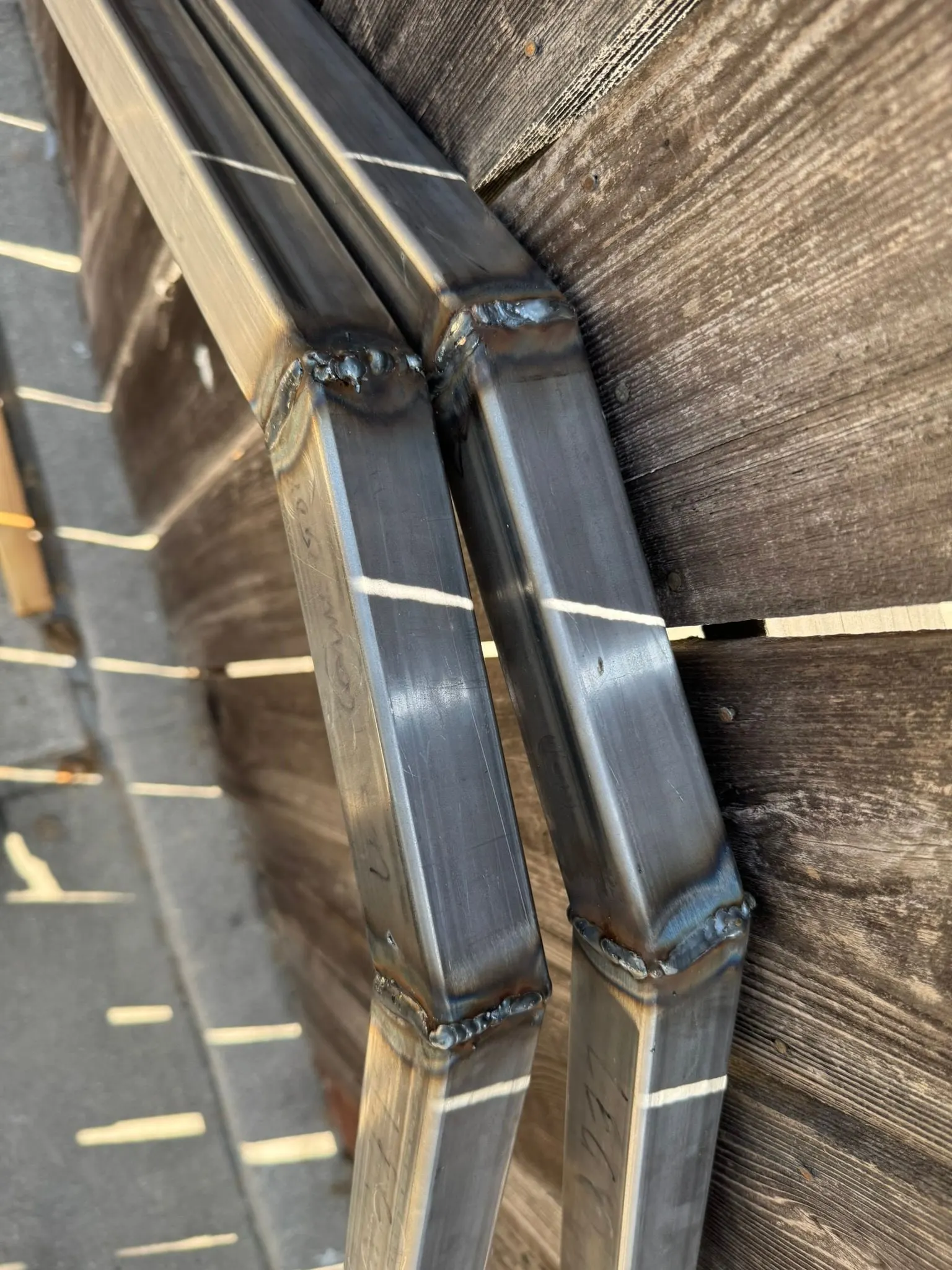 Close-up of a rough butt weld on square tube