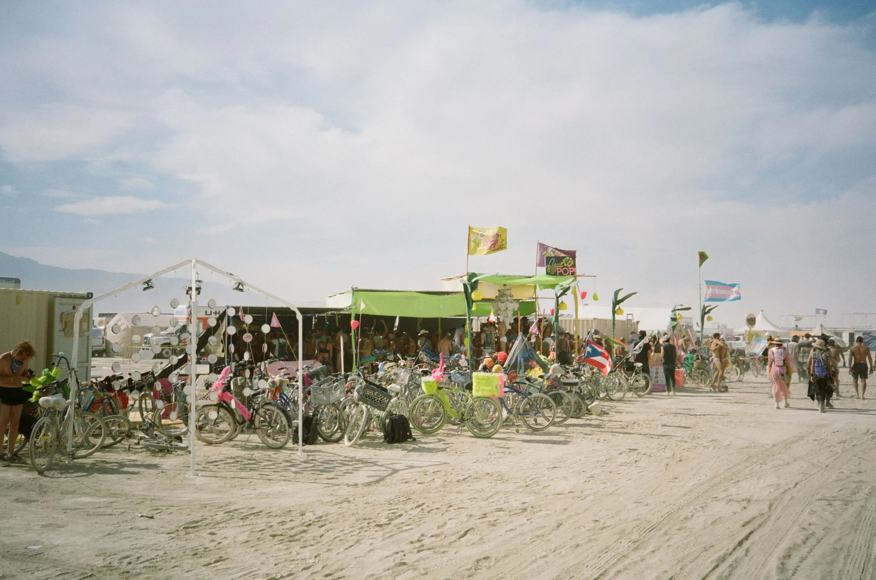 Film photo of the installation and parked bikes in front of camp